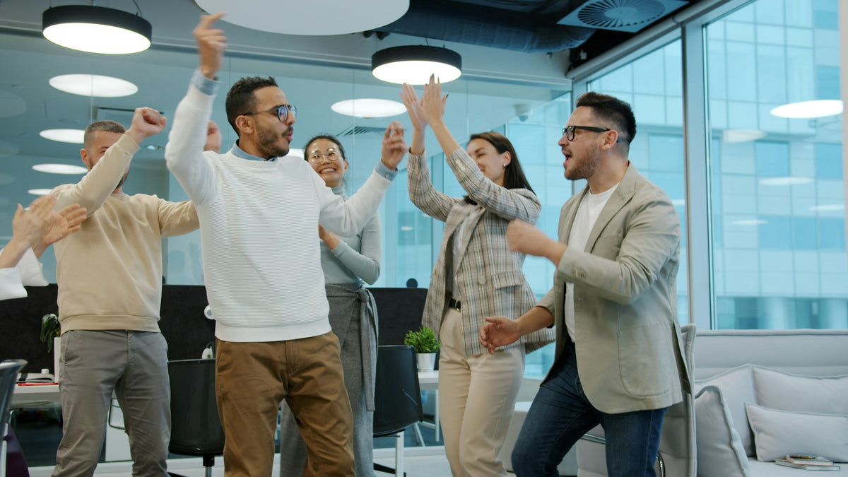 Sales team celebrating a success in the office