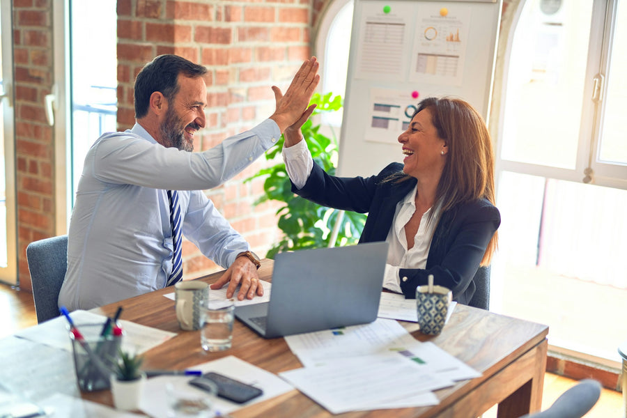 Two business partners giving each other a high five
